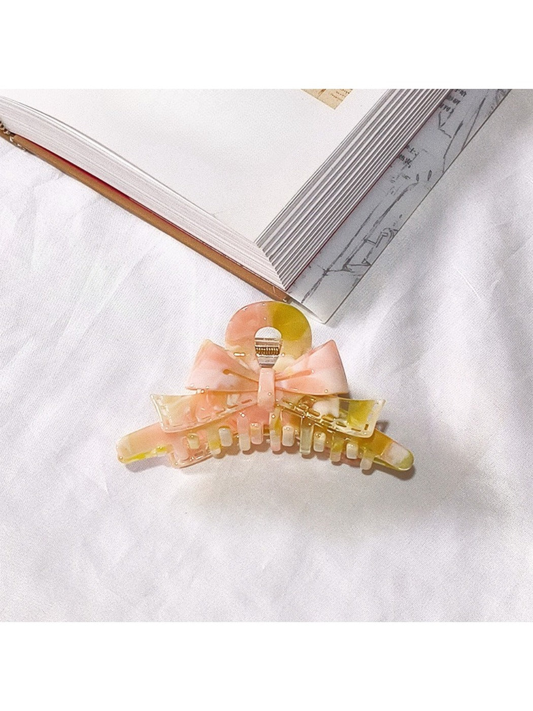 Beau acetate bow shaped claw clip photographed from low angle