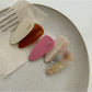 Close-up of Beau acetate pink tone hair clip with glossy finish