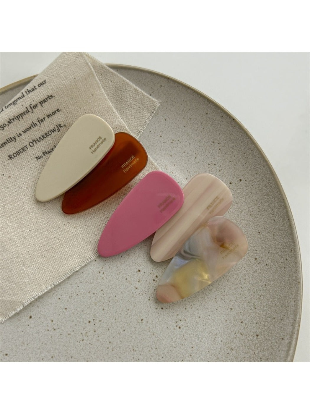 Close-up of Beau acetate pink tone hair clip with glossy finish
