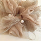 Gifty scrunchie worn in hair, highlighting the bow and gathered fabric design