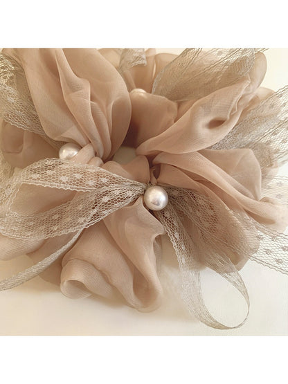 Gifty scrunchie worn in hair, highlighting the bow and gathered fabric design