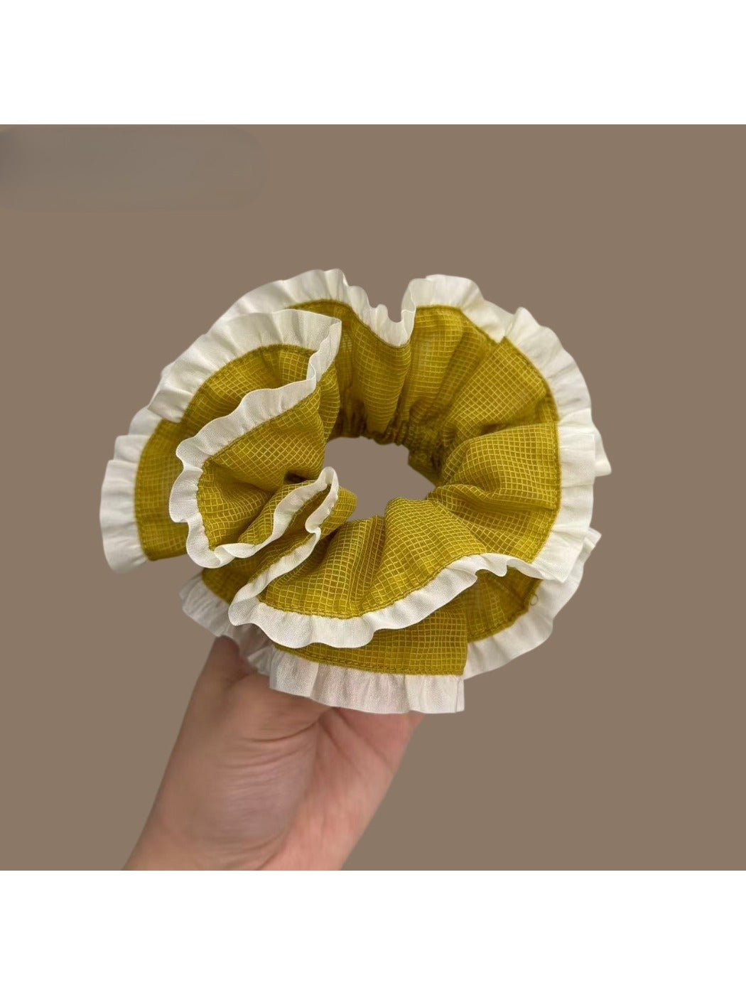 Green plaid scrunchie with white trim on a white background