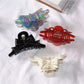Side view of Beau acetate bow shaped claw clip displaying clip mechanism