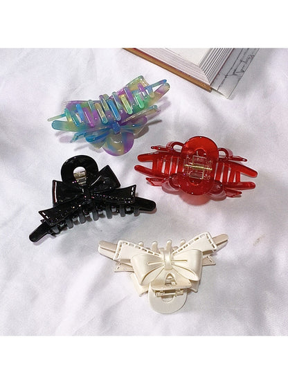 Side view of Beau acetate bow shaped claw clip displaying clip mechanism