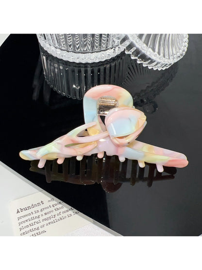 Beau hair claw clip placed on wooden surface with natural lighting