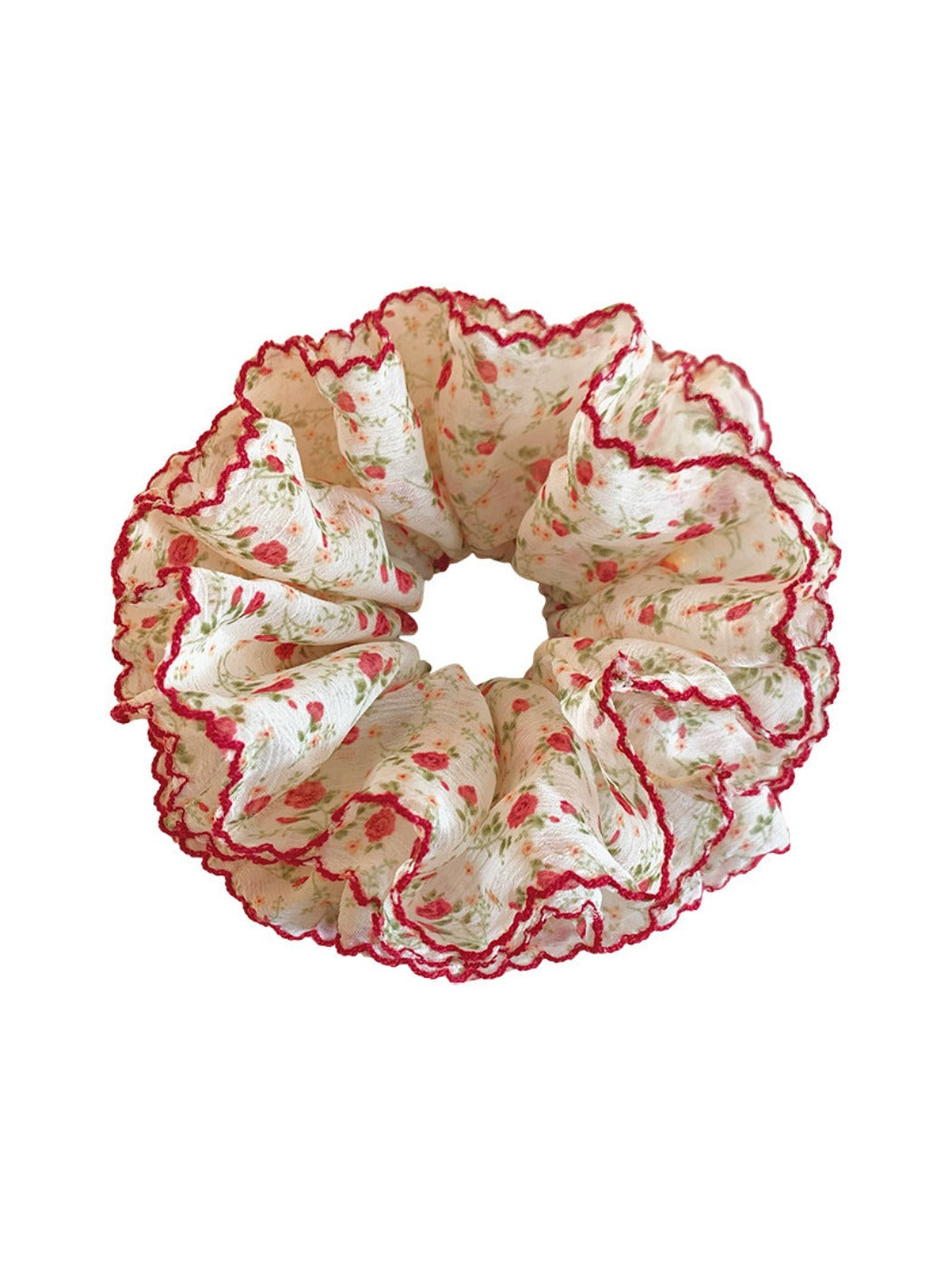 Red floral scrunchie worn on wrist as a hair accessory