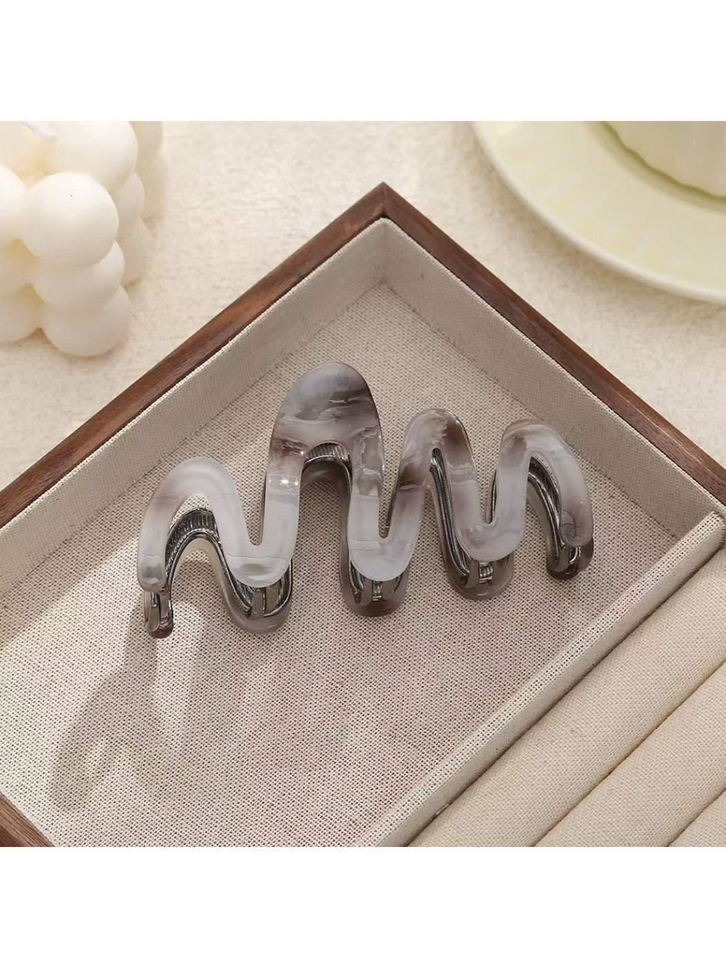 Model using Beau hair clip to secure half-up hairstyle