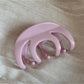 Beau hair clip in matte black resting on a white surface