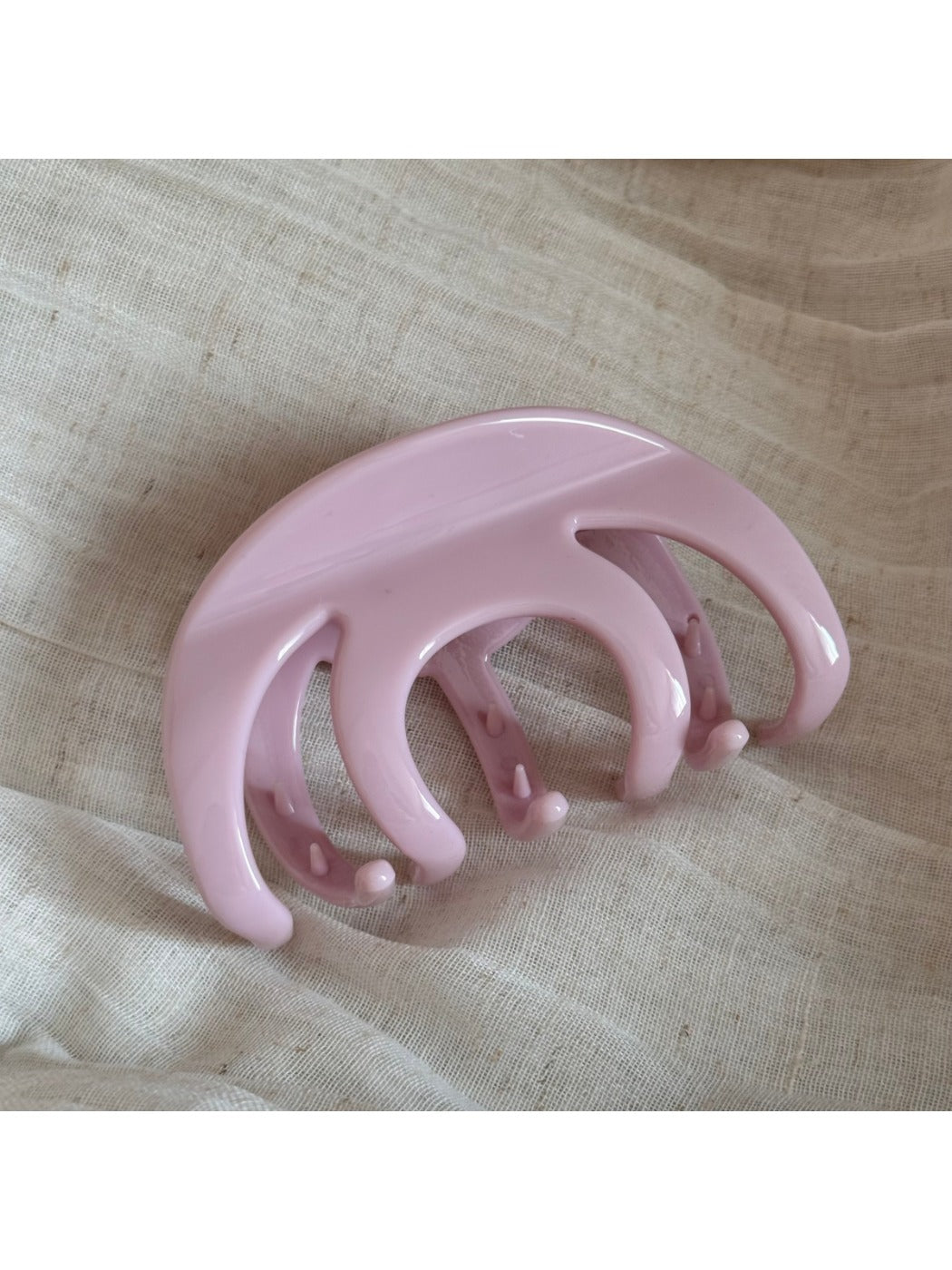 Beau hair clip in matte black resting on a white surface