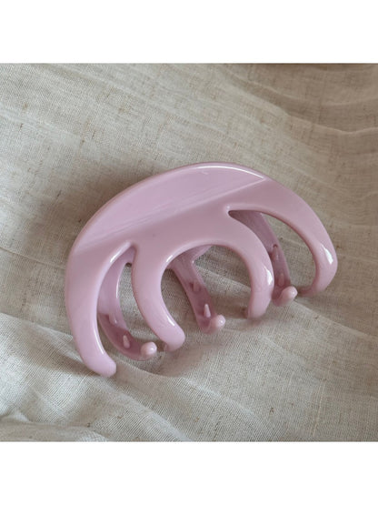 Beau hair clip in matte black resting on a white surface
