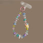 Close-up of Keypus beaded phone strap keychain with colorful beads and gold accents