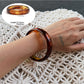 Multiple Lovra ombre bangle bracelets stacked on wrist in gradient colors