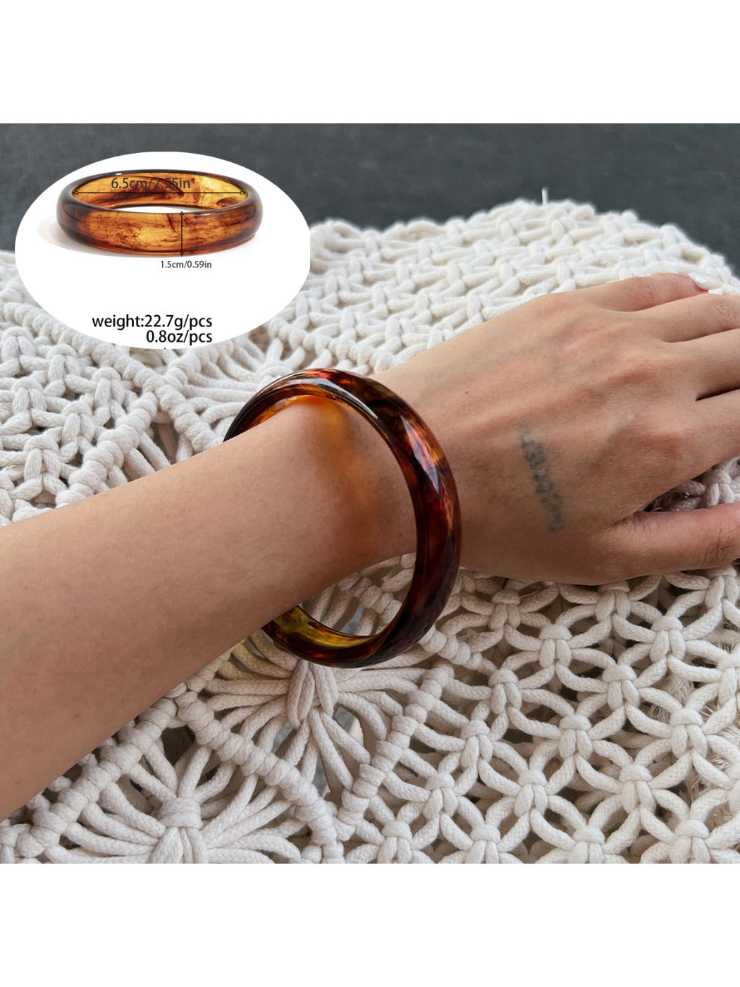 Multiple Lovra ombre bangle bracelets stacked on wrist in gradient colors