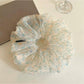 Large green tulle scrunchie with tiny white and pink floral pattern