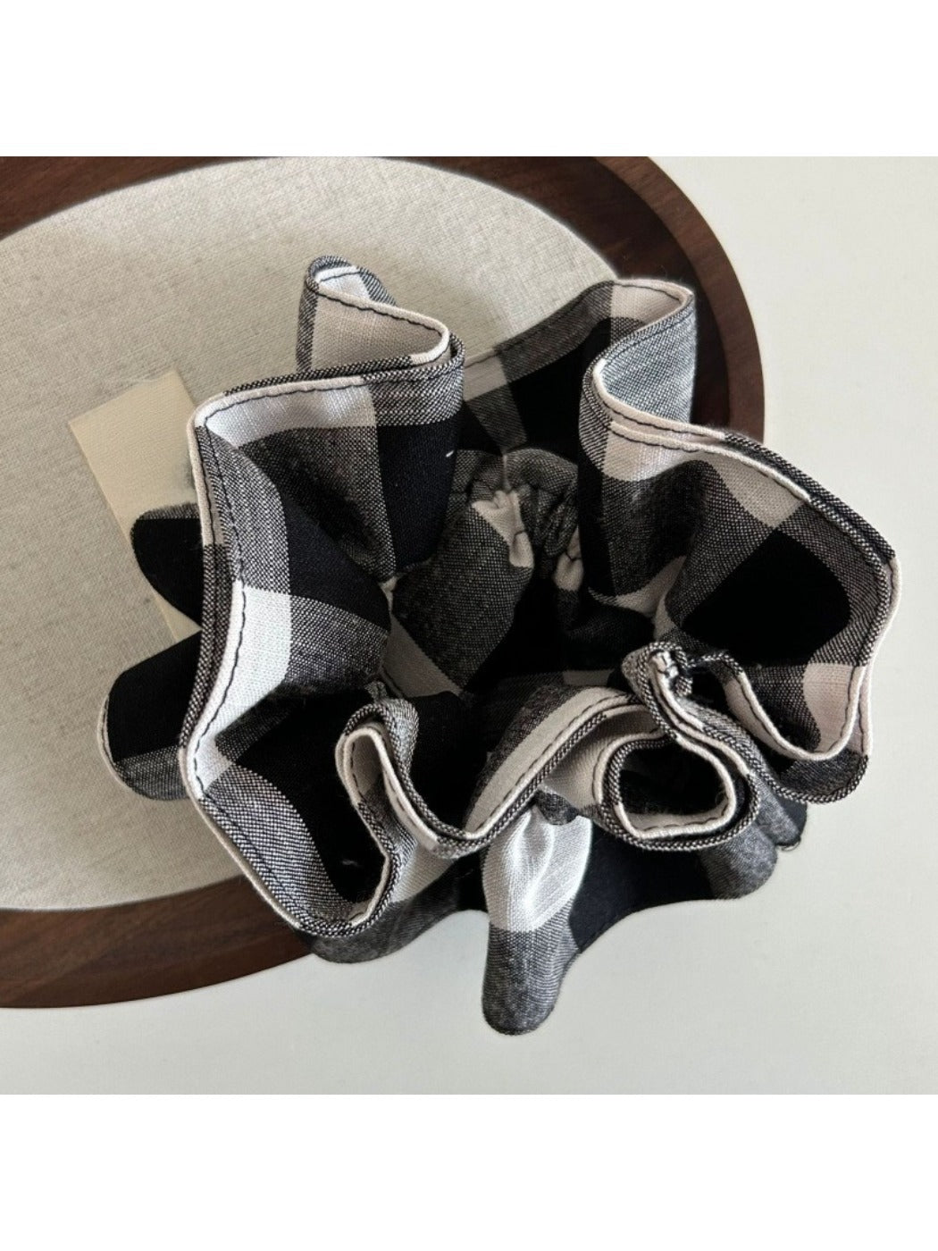 Side view of black and white checkered vintage scrunchie