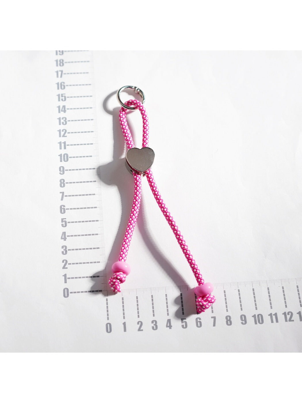 Close-up of multicolored rope heart keychain showing detailed texture