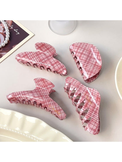 Side view of Beau pink plaid crescent shaped claw clip showing clasp mechanism