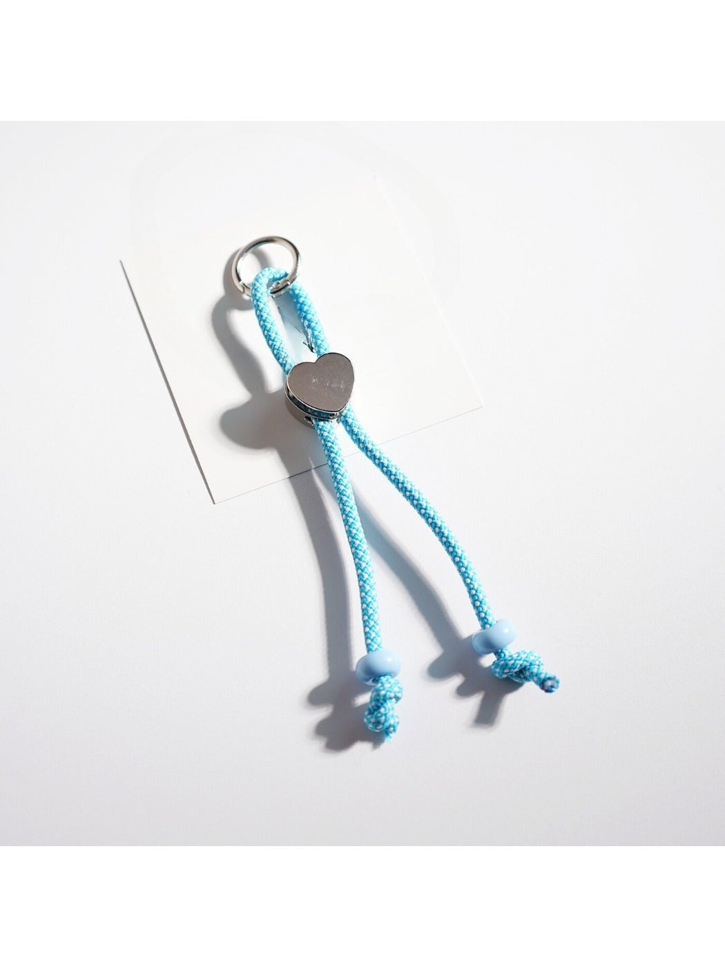 Keychain featuring a heart shape made from intertwined colorful ropes