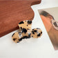 Beau hair claw clip on a fabric surface highlighting texture and color