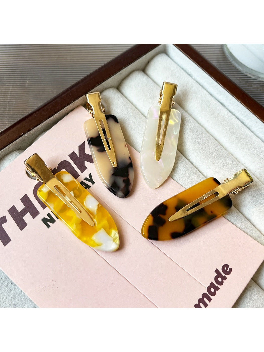 Close-up of Beau acetate invisible hair clip highlighting smooth curved edges