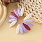 Earedge fan-shaped earrings laid flat showing full shape and color pattern