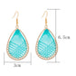 Earedge Cord Woven Teardrop Earrings hanging on a white display stand