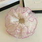 Close-up of Gifty sweet colorful polka dot tulle scrunchie fabric texture