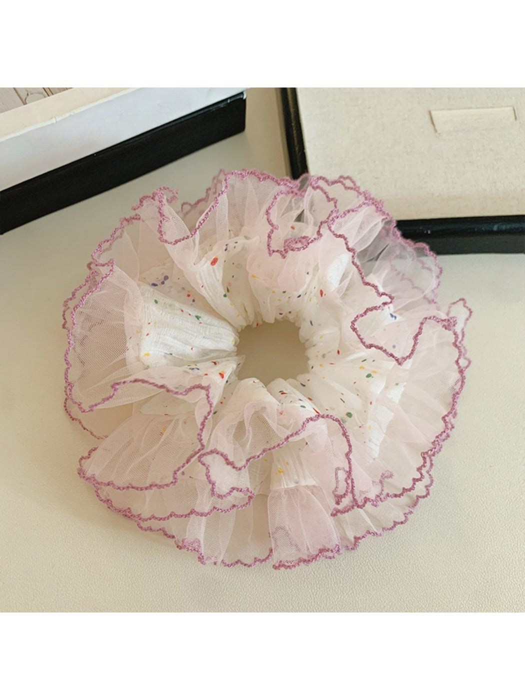 Close-up of Gifty sweet colorful polka dot tulle scrunchie fabric texture