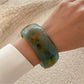 Lovra vintage minimalist round bangle bracelet paired with other delicate gold jewelry
