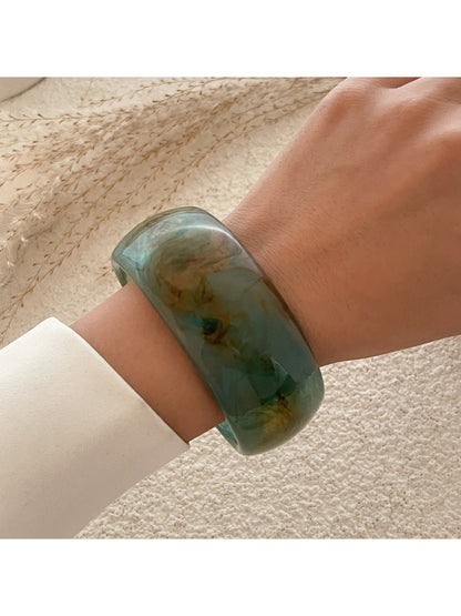 Lovra vintage minimalist round bangle bracelet paired with other delicate gold jewelry