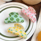 Beau fruit print half circle shark claw hair clip on white background