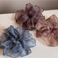 Close-up of pink tulle scrunchie showing glitter details and texture