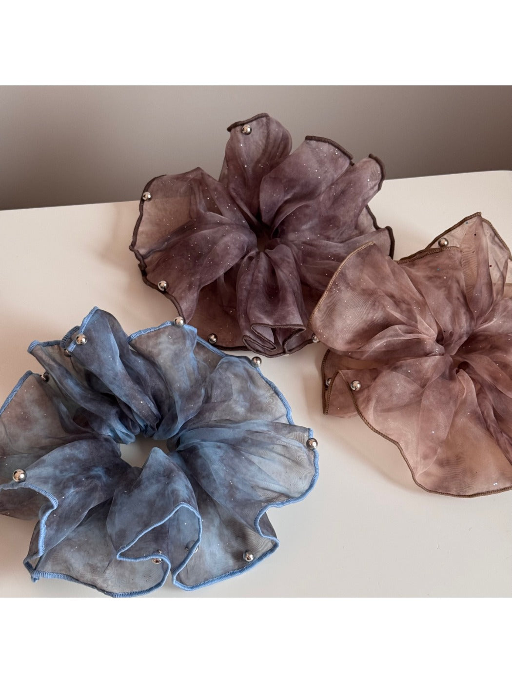 Close-up of pink tulle scrunchie showing glitter details and texture