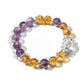 Close-up of Lovra yellow and purple crystal bracelet on white background