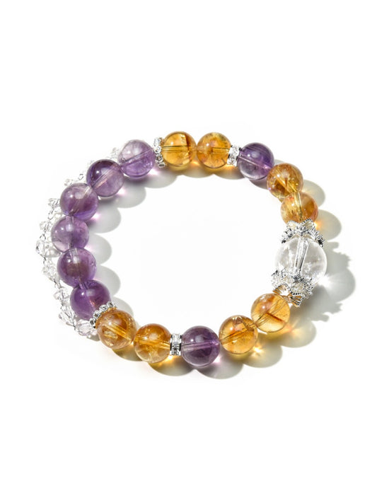 Close-up of Lovra yellow and purple crystal bracelet on white background