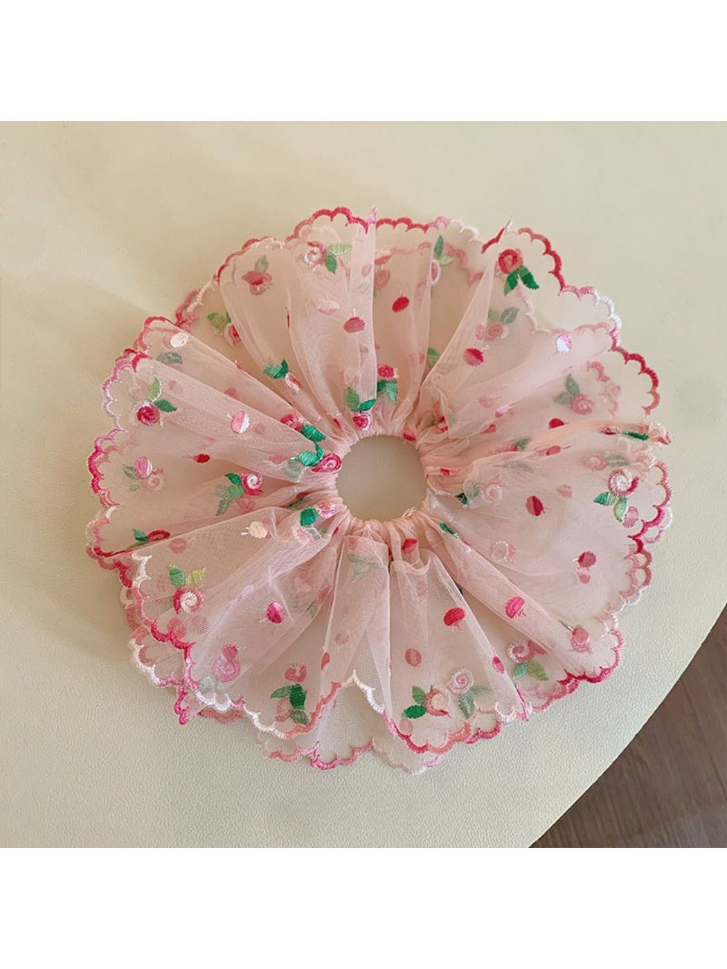Close-up of pink double layered ruffled scrunchie on white background