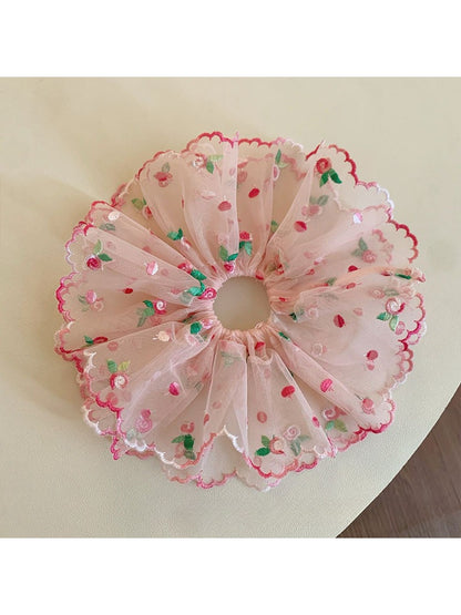 Close-up of pink double layered ruffled scrunchie on white background