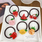 Set of colorful hair ties decorated with cute fruit charms including strawberries and oranges