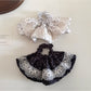 Close-up of Gifty vintage polka dot hair tie in black with white dots