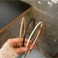 Side view of Gifty minimalist headband in muted beige tone
