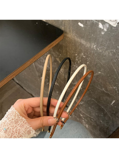 Side view of Gifty minimalist headband in muted beige tone