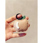 Apple keychain held in hand showing compact size and smooth finish