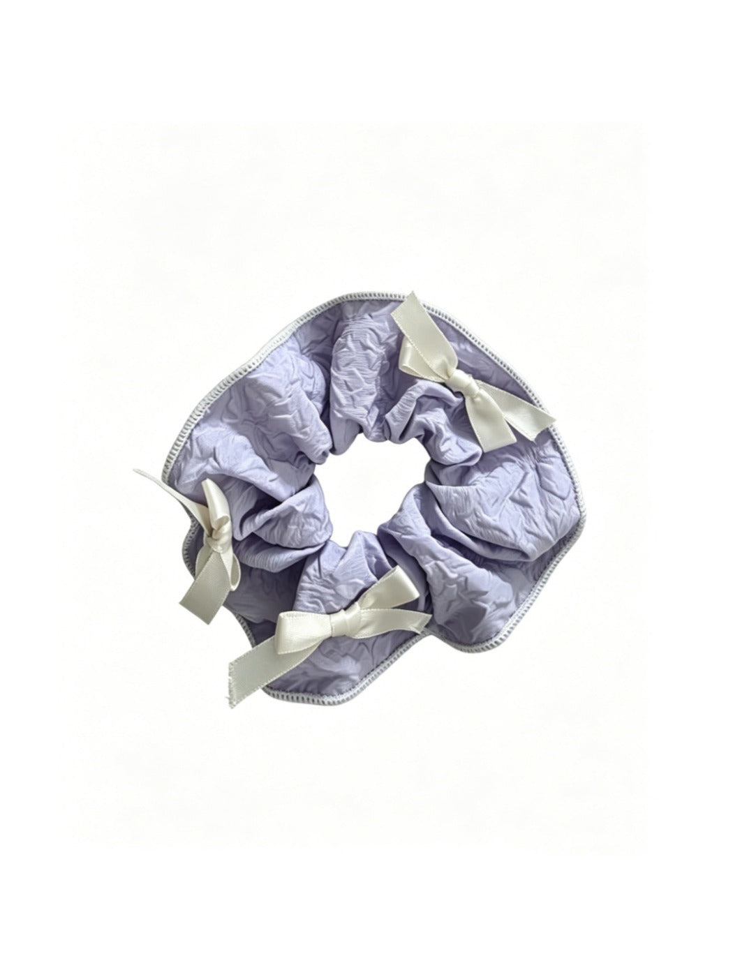 Gifty scrunchie with red ribbon bow displayed on a wooden surface