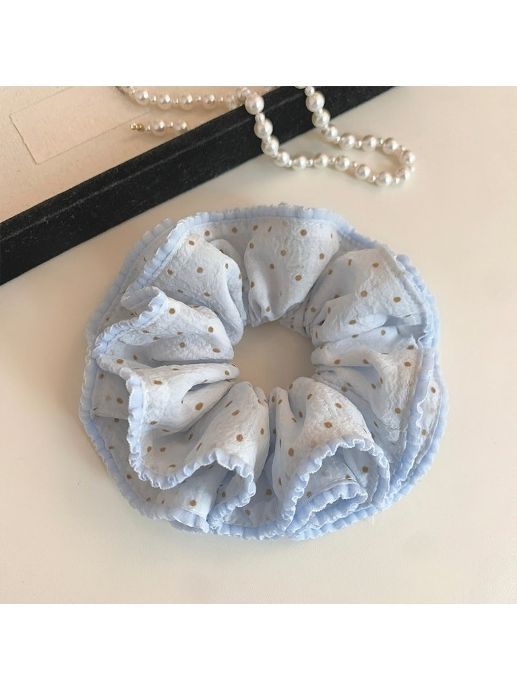 Close-up of Gifty Sweet Polka Dot Double Scrunchie in pink with white dots