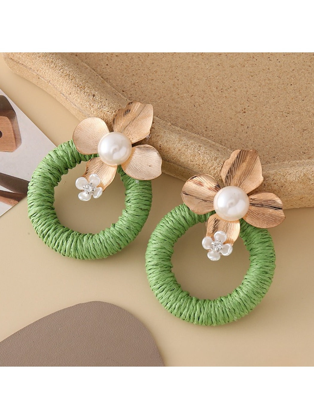 Model wearing Earedge round floral pendant earrings with floral pattern