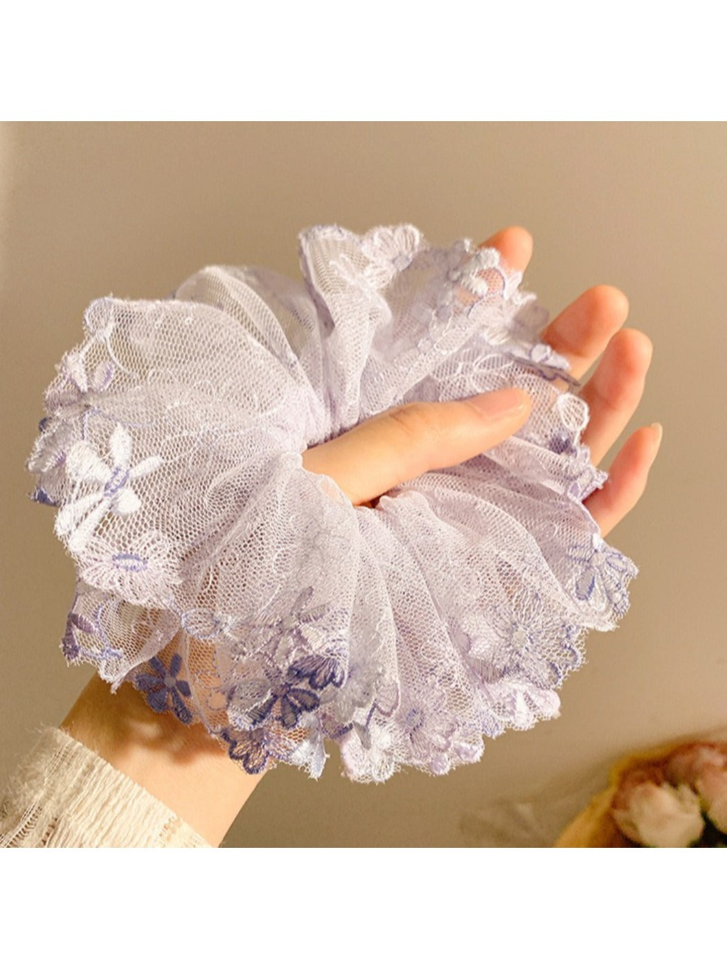 Gifty scrunchie displayed on a white background highlighting ruched floral design