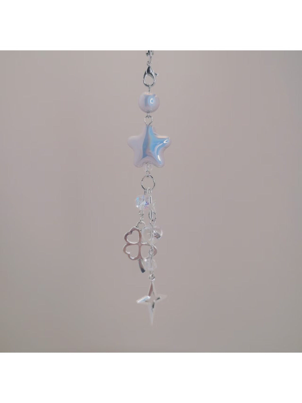 Back view of iridescent star keychain showing smooth surface