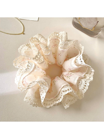 Gifty Sweet Bow Print Ruffled Scrunchie styled in hair with visible pink bow print and ruffles