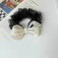 Gifty mesh bow acetate scrunchie in pastel color next to matching accessories