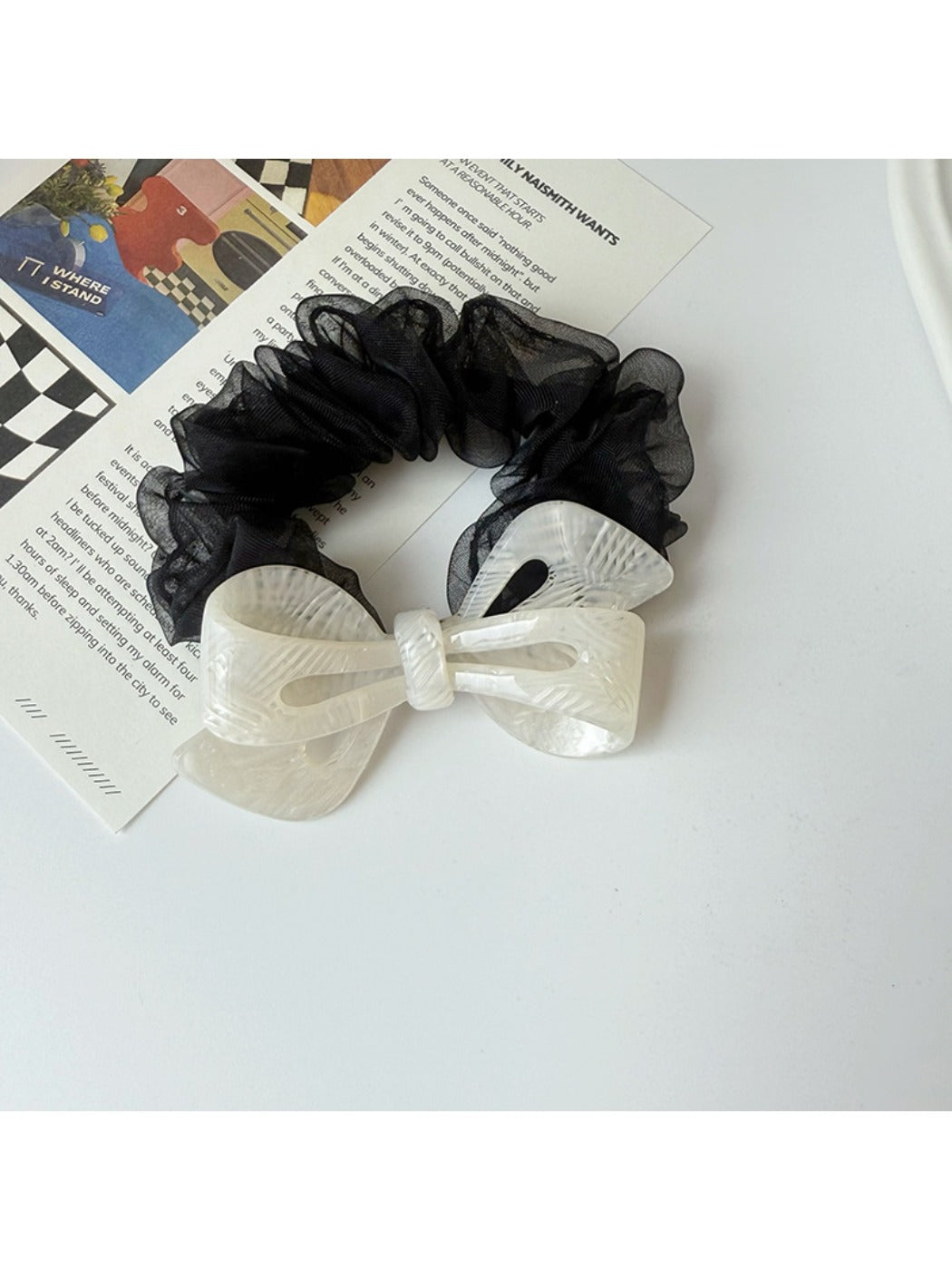 Gifty mesh bow acetate scrunchie in pastel color next to matching accessories